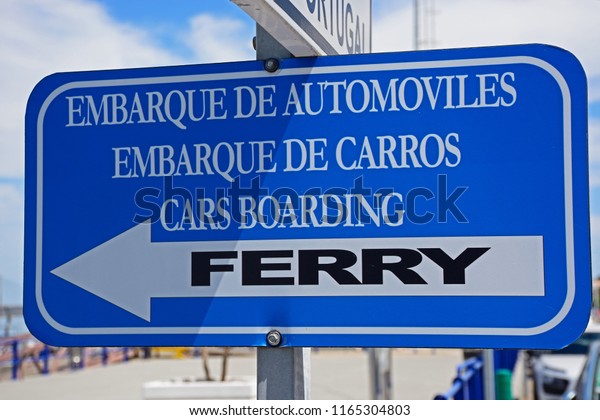 Blue and white\
cars boarding Ferry sign along the waterfront, Ayamonte, Huelva\
Province, Andalucia, Spain,\
Europe.