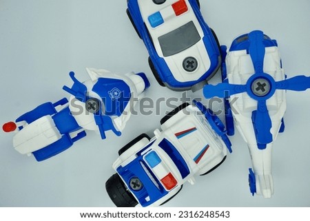 Blue and white cars, helicopters, and motorbikes parked on a white background
