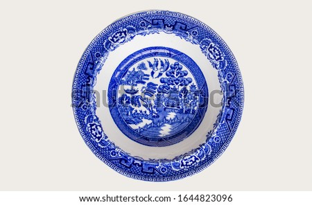 Blue and white decorated ceramic plate isolated on white background with space for text
