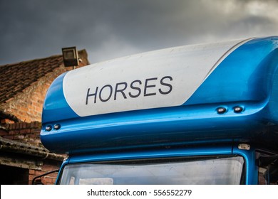 Blue & White horse wagon with horses written on the front