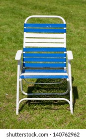 Blue and white lawn chair on grass.