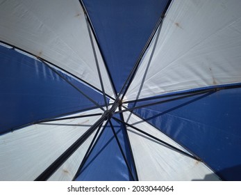 Blue And White On The Inside Of The Open Umbrella.