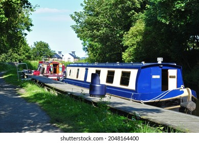 Blue and White Painted Narrow Boat Moored beside Jetty on Old Industrial Canal 