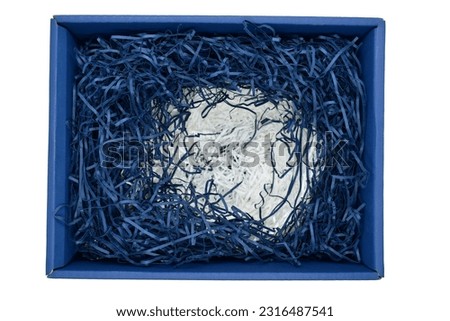 blue and white paper filler in carton cardboard box isolated on white background