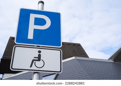 Blue and white parking sign with wheelchair for drivers with disabilities