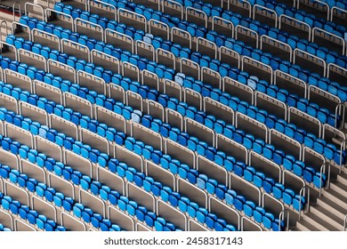 Blue and white stadium seats arrayed in a diagonal pattern, showcasing a visually striking contrast and structure in an empty stadium. - Powered by Shutterstock - Get 15% off with code: PIKWIZARD15