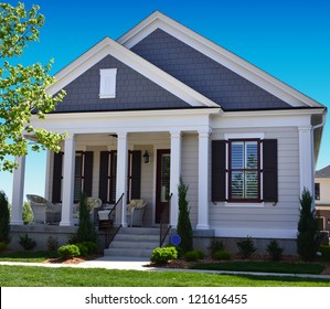 Blue And White Suburban American Cape Cod Home With Front Porch