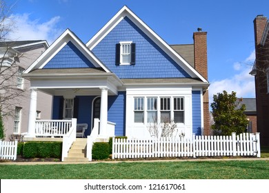 Blue and White Suburban American Cape Cod Home with Front Porch