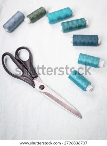 Blue and white thread spools on white surface, sewing, threads, 