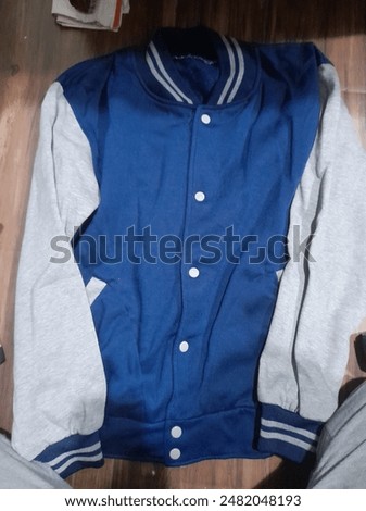 a blue and white varsity jacket combination