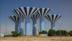 Blue And White Water Towers In Kuwait View , Middle East. Blue Sky And Mosque On Background