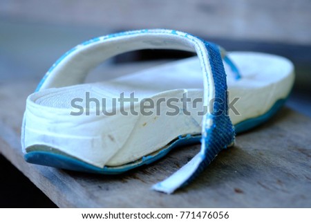Blue and white women's shoes is tear.