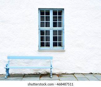 Blue window, blue bench and white wall