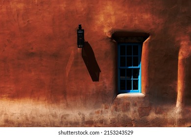 A Blue Window In A Pueblo Style Wall