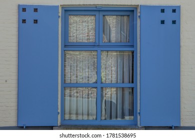 Blue Window with shutter on the Facade