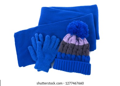 Blue winter knitted bobble hat, scarf gloves isolated 