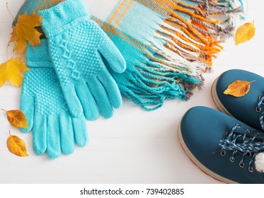 blue winter shoes and gloves on white wooden background