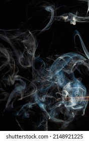 Blue wisp of smoke on black background