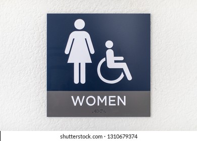 Blue Womens Bathroom Sign On A White Wall