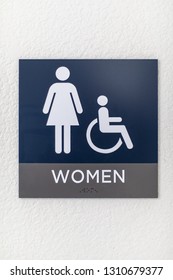 Blue Womens Bathroom Sign On A White Wall