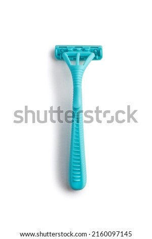 Blue women's razor on a white vertical background. Plastic razor on an isolated white background. The concept of smooth skin care and fighting hair in an unnecessary place