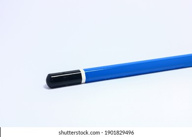 A Blue Wooden Pencil Can Visible Only On The Tip Of The Pencil Is Placed On A White Background.