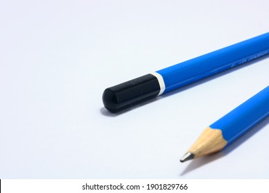 A Blue Wooden Pencil Can Visible Only On The Tip Of The Pencil Is Placed On A White Background.