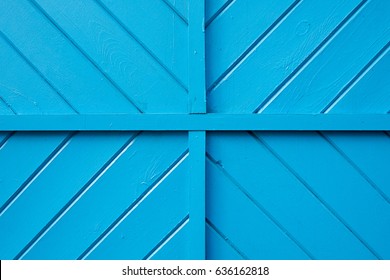 A Blue Wooden Wall With Quadrants And Diagonal Patterns.