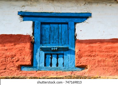 A blue wooden window of a traditional house in Nepal