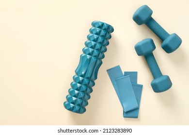 Blue workout equipment set on beige background. Dumbbells, fitness tape, roller. Flat lay, top view. - Shutterstock ID 2123283890