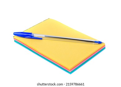 Blue Writing Pen On Unlined Note Pad With Rainbow Colored Tear Off Pages Isolated Over White