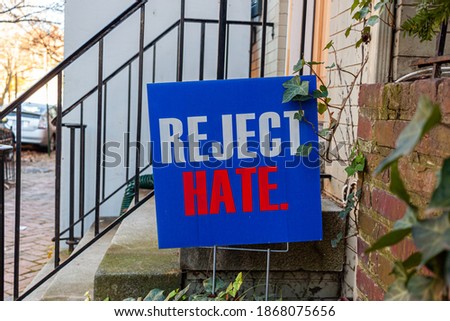 A blue yard sign that says Reject Hate is placed on the front yard of an old building ahead of US elections to ease political tension and social unrest which has peaked in the recent months.