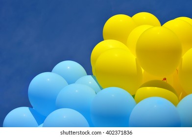 Blue And Yellow  Balloons In The City Festival On Blue Sky Background