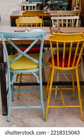 Blue And Yellow Chairs. Colorful Seat With Table In Creative Design. Empty Wooden Furniture In Restaurant. Outside. Place For Rest. Nobody.