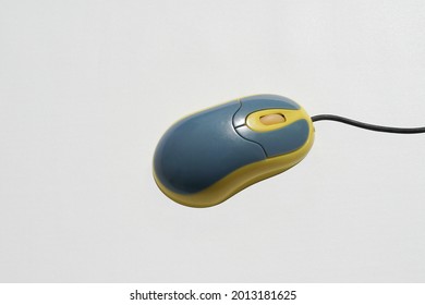 Blue Yellow Computer Mouse On A White Background