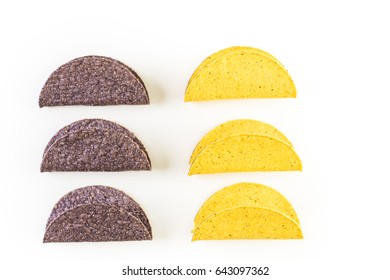 Blue and yellow corn taco shells on a white background.