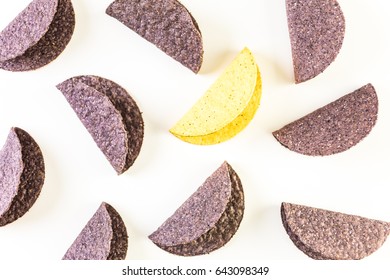 Blue and yellow corn taco shells on a white background.