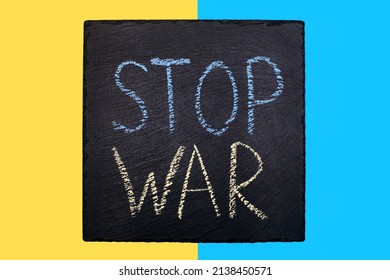 Blue With A Yellow Flag Of Ukraine And A Sign With The Inscription Stop War. A Call For Help To The World Community To Stop The War. Military Aggression And Russian Attack On Ukraine