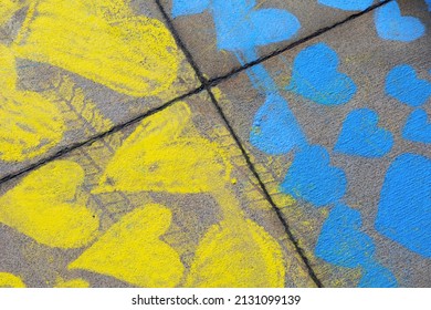 Blue and yellow hearts as national flag of Ukraine. Symbol of support and solidarity with Ukrainian nation. Rough surface and material with hand-drawn drawing.