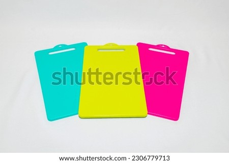 The Blue, Yellow, and Pink Plastic Cutting Board is a set of vibrant and practical kitchen essentials.