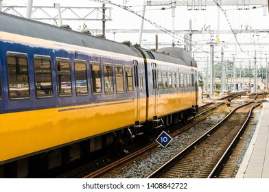 Blue And Yellow Train Leaving Utrecht Centraal Station