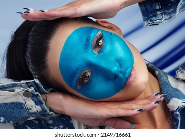 Blue Is Your New Favourite Colour. Studio Portrait Of A Beautiful Young Woman Posing Against A Grey Background.