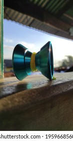 A Blue Yoyo That Reflects Sunlight 