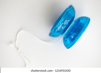 Blue Yo-yo Yo Yo Toy With A Knotted String On A White Background