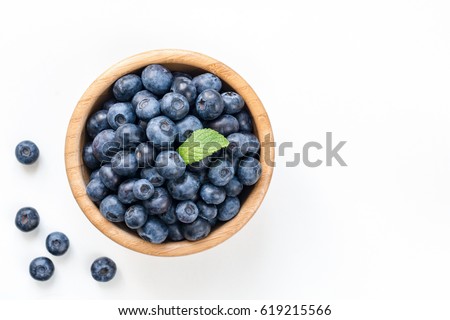 Blueberries in bowl isolated on white background