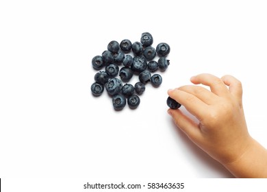Blueberries in the children's hands isolated on white background. The concept of summer berry crops, organic food, vitamins