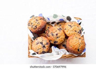 blueberries muffins close up in a basket 