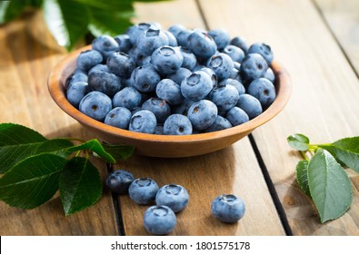 Blueberries in a plate, on an old background.