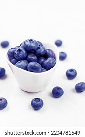 Blueberries In The White Bowl Above White Background