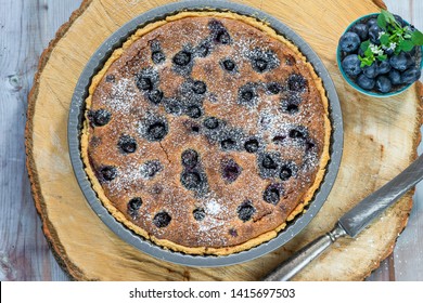 Blueberry And Almond Tart Dusted With Icing Sugar - Overhead View